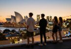 Young rich Australians overlooking city lights at sunset.
