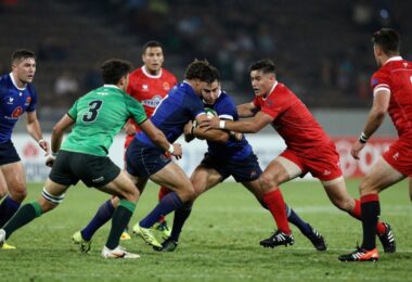 Rugby players in action on a field.
