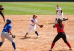 Softball players in action on a sunny field.