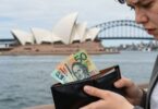 Australian person worried about money near landmarks.