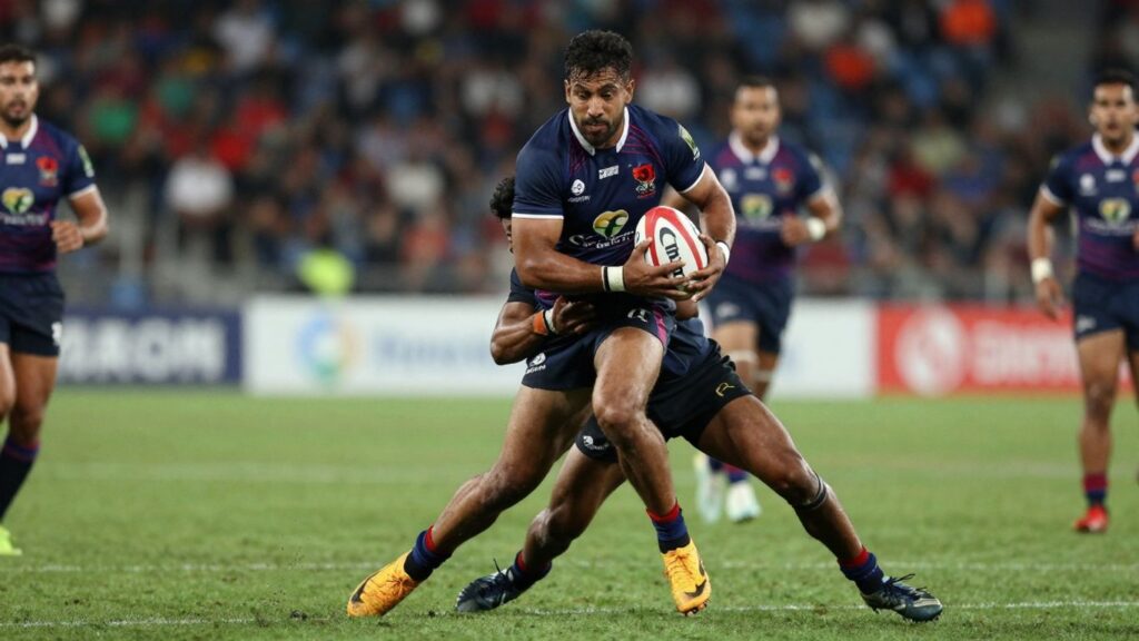 Rugby league players in a fierce tackle on a grass field.