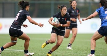 Rugby league players in action on a green field.