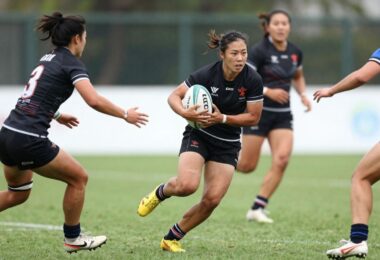 Rugby league players in action on a green field.