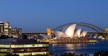 Sydney skyline with Salesforce building at dusk.