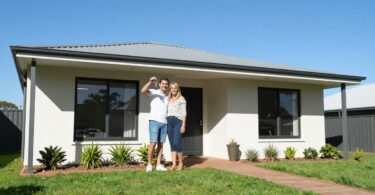 Couple holding keys outside a new South Australian home.