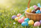 Easter eggs and chocolate treats on green grass.