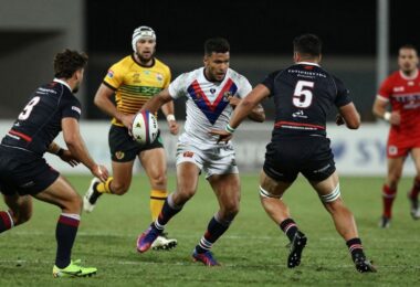 Rugby league players in action on a field.