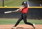 Softball player swinging bat at Penrith game.