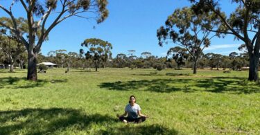 Person meditating in Australian nature, healing.