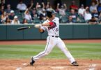 Fresno Eagles baseball player swinging bat on field.