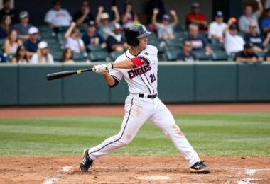 Fresno Eagles baseball player swinging bat on field.
