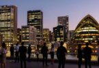 Australian startup scene with city skyline and professionals.