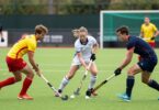 Ryde Hockey Club players in action on a grassy field.