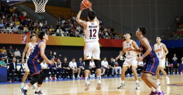 Moreton Bay Suns basketball players in action on court.