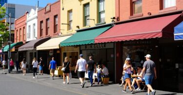 Melbourne street with small businesses and people walking.