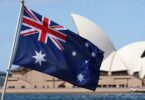 Australian flag with Sydney skyline in background.