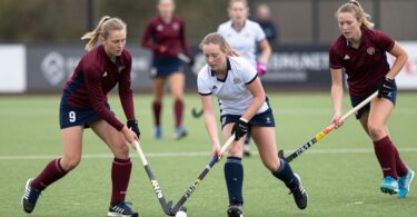 Ryde Hunters Hill hockey players in action on the field.