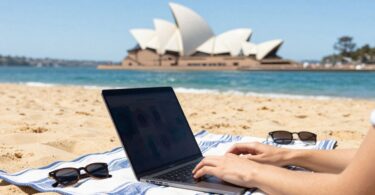 Person earning money online on Australian beach.