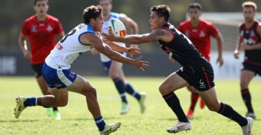 Oztag players in action on a sunny field.