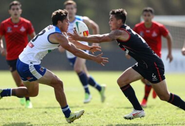 Oztag players in action on a sunny field.