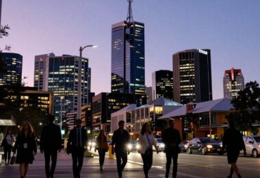 Adelaide cityscape at dusk, professionals walking below.
