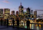 Melbourne skyline at dusk with business professionals.