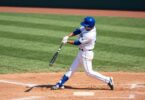 Arncliffe Scots baseball player swinging bat on field