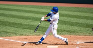 Arncliffe Scots baseball player swinging bat on field