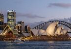 Sydney skyline at dusk with Opera House and Harbour Bridge.