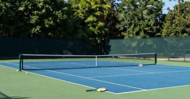 Tennis court at Discovery Park Tennis Club, rackets and balls.