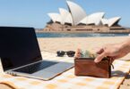 Earning money from home in Australia with beach backdrop.