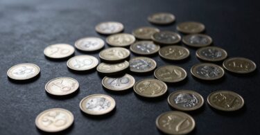 Australian cash rewards coins and banknotes scattered.