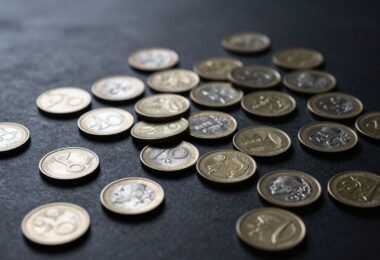 Australian cash rewards coins and banknotes scattered.