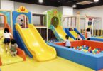 Kids playing in a colourful indoor playground.
