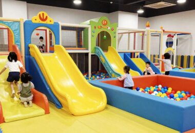 Kids playing in a colourful indoor playground.