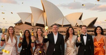 Australian business owners celebrating with trophies at sunset.