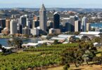 South Australian business landscape: vineyards, city, harbor, industry.
