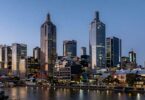 Melbourne skyline at dusk with river reflections.