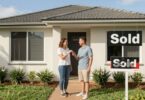 Couple with keys outside Australian home